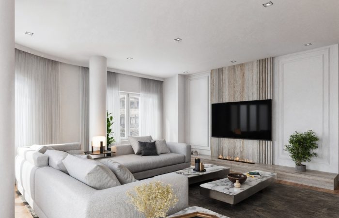 Proyecto de interiorismo residencial y reforma integral de lujo en Bilbao y Donostia por CTEstudio. Salón moderno con sofá modular gris, mesas de centro de mármol, chimenea integrada de diseño y panel de madera para televisión.